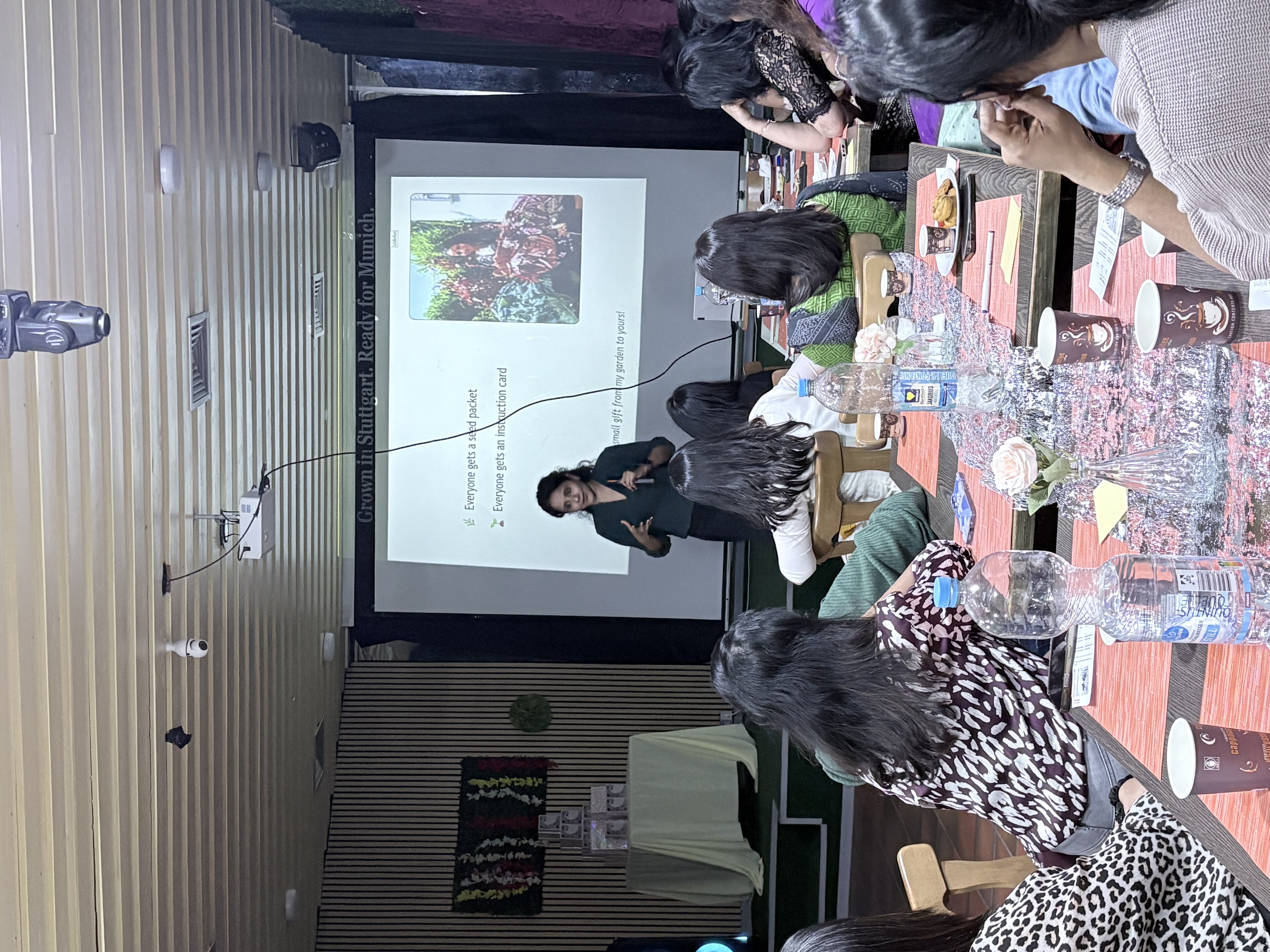 Aparna presenting to the Malayali community in Munich on Women's Day 2026